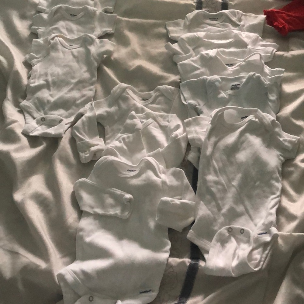 11 brand new Gerber white onesies.